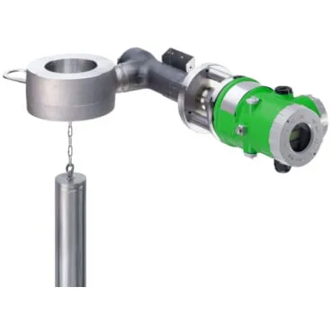 A buoyancy-type level transmitter, showing the green instrument head connected to a cylindrical metal displacer that hangs from a short chain.